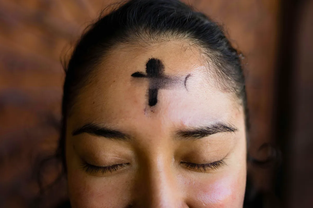 Woman smiling with ash cross on her forehead