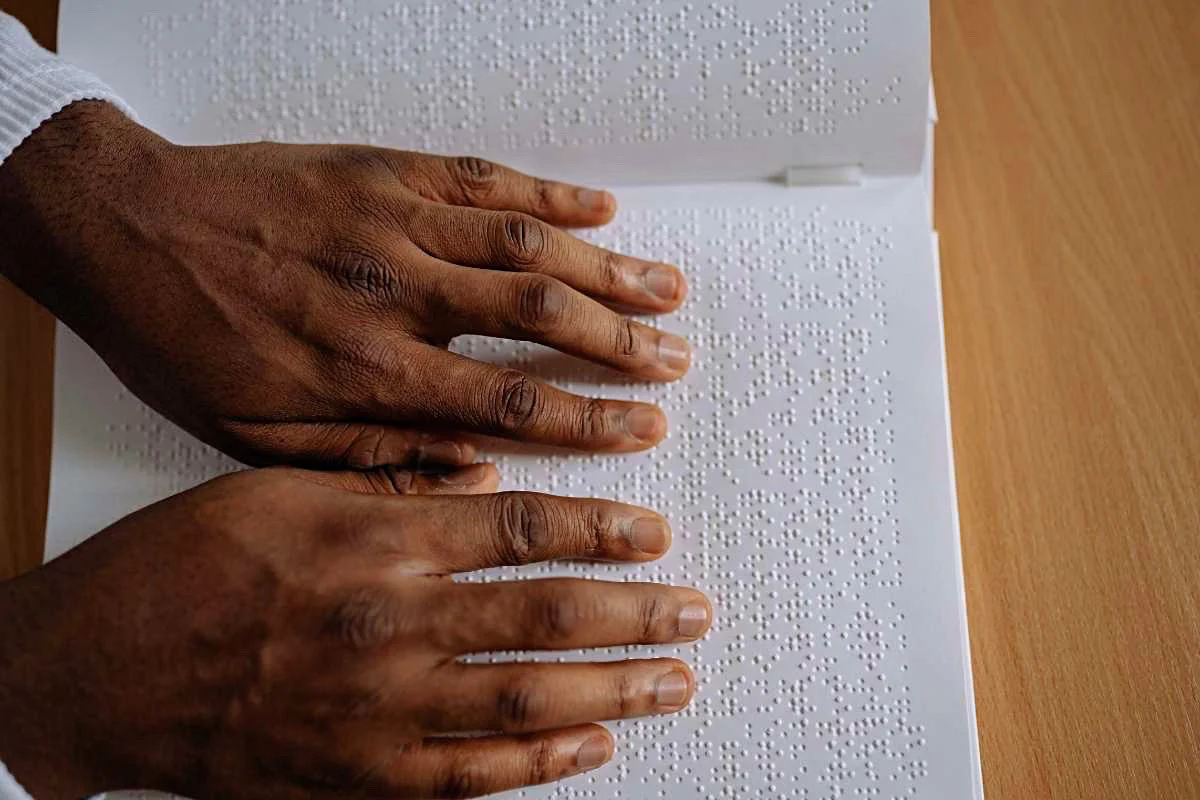 Mans hands reading braille