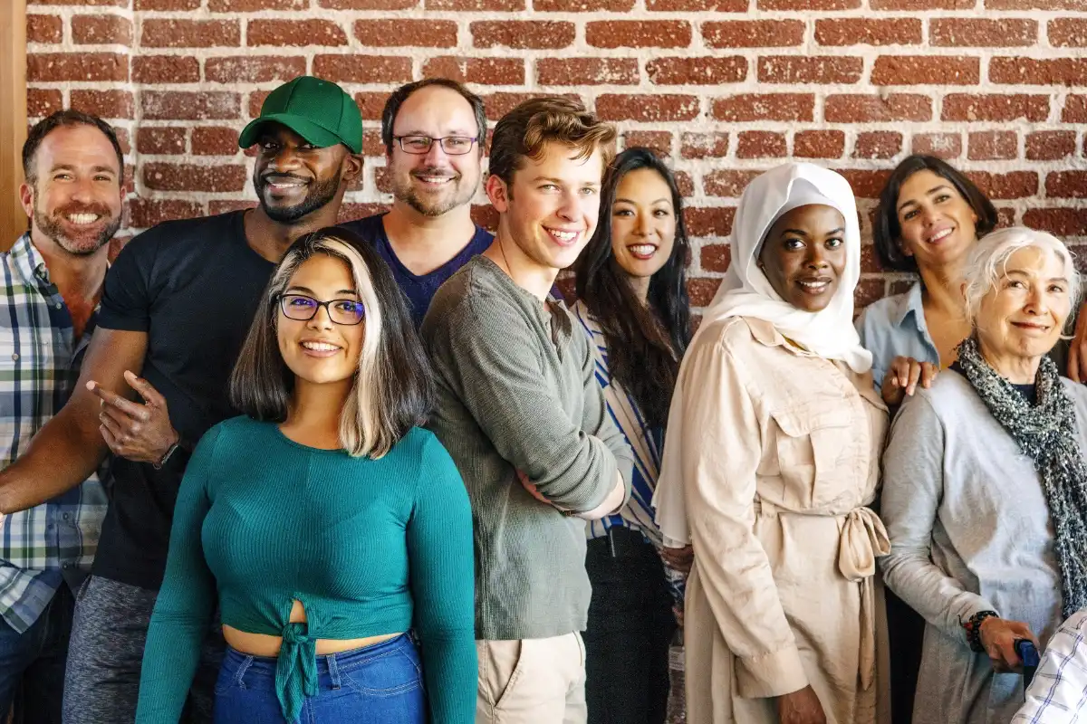 A group of smiling people of mixed ages, genders, races and religions