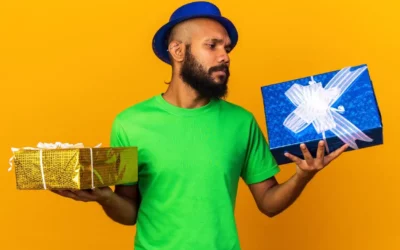 Man holding 2 gifts while looking at one of the gifts suspiciously - Happy Mind Training Blog | Effective Feedback