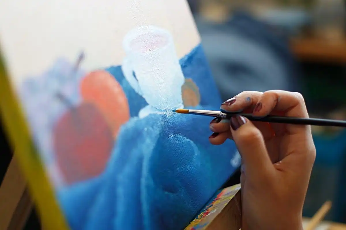 Person painting on canvas - Happy Mind Training Blog | How to Know Your Worth