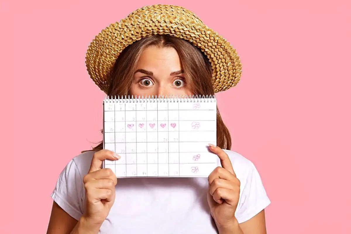 Person holding a calendar in front of her mouth and nose- Happy Mind Training Blog | How to Start Journaling