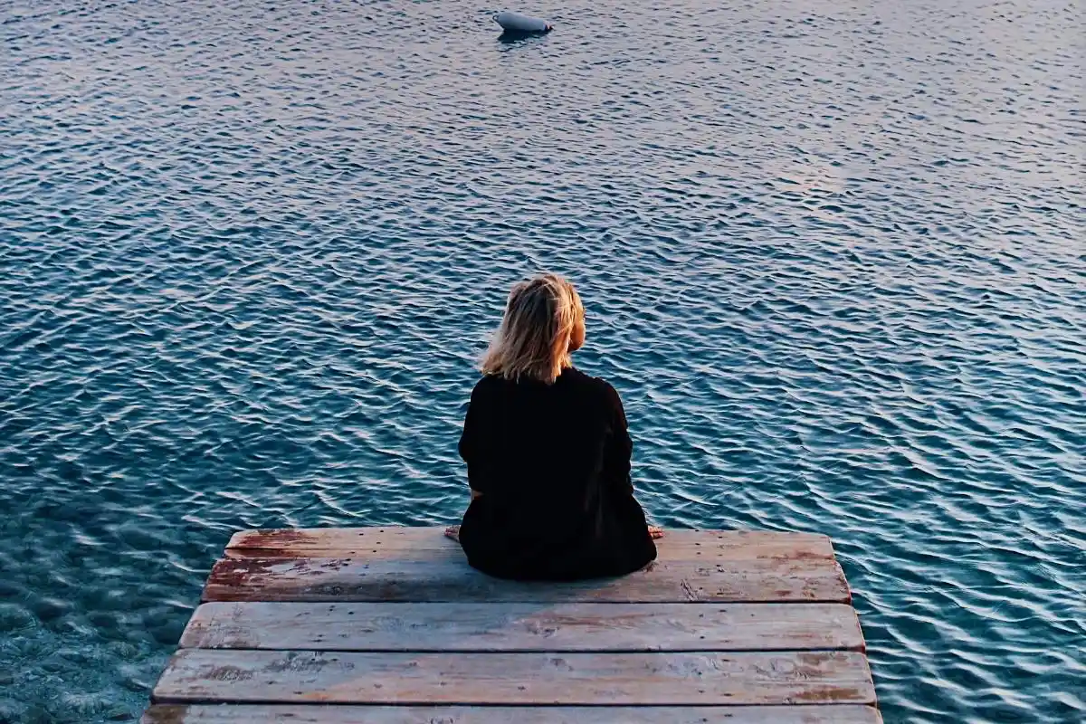 Happy Mind Training Blog | Into The Blue - person sitting by the water