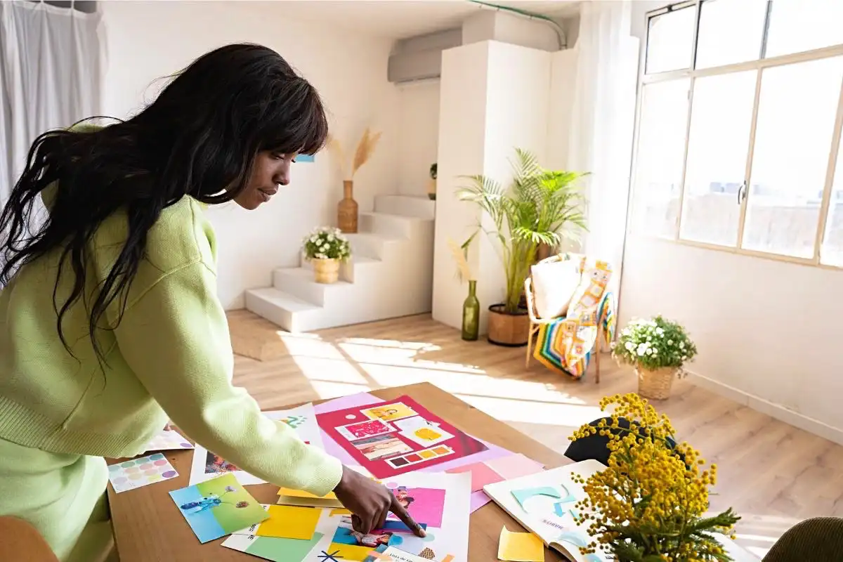 Woman looking at colourful documents related to interior design - Happy Mind Training Blog | Lost Art of Doing Nothing