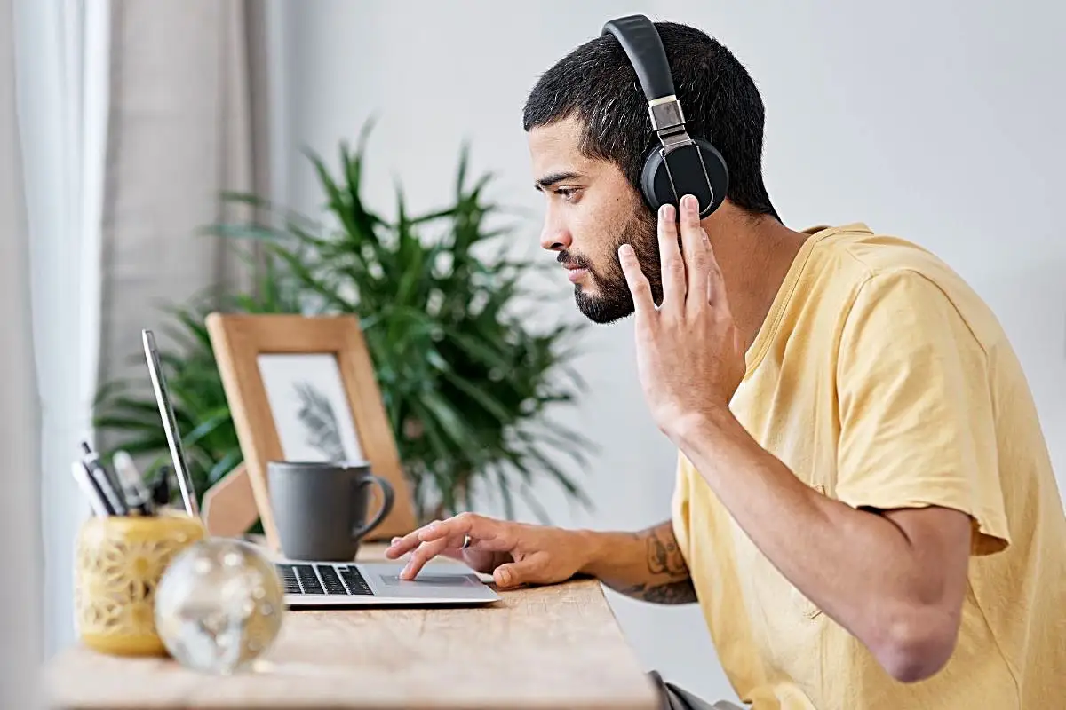 Happy Mind Training Blog | Neurodiversity at Work - man wearing headphones working on laptop