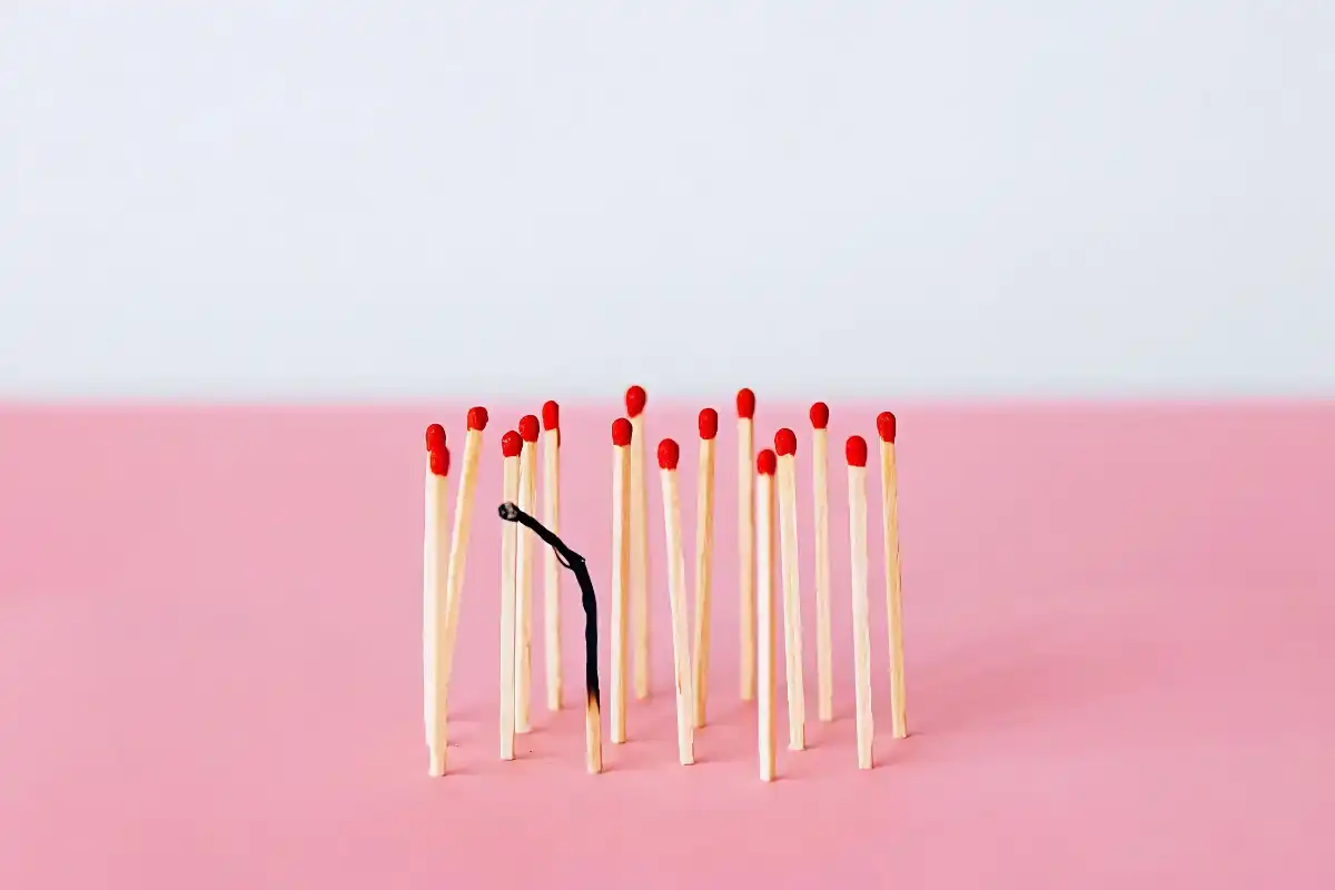 A bunch of matches standing up with one being mostly burned out - HappyMind Training Blog | Pouring From an Empty Cup
