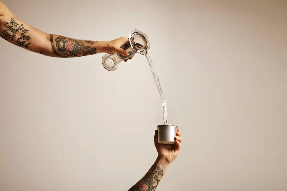 Water being poured from a jug into a cup - HappyMind Training Blog | Pouring From an Empty Cup