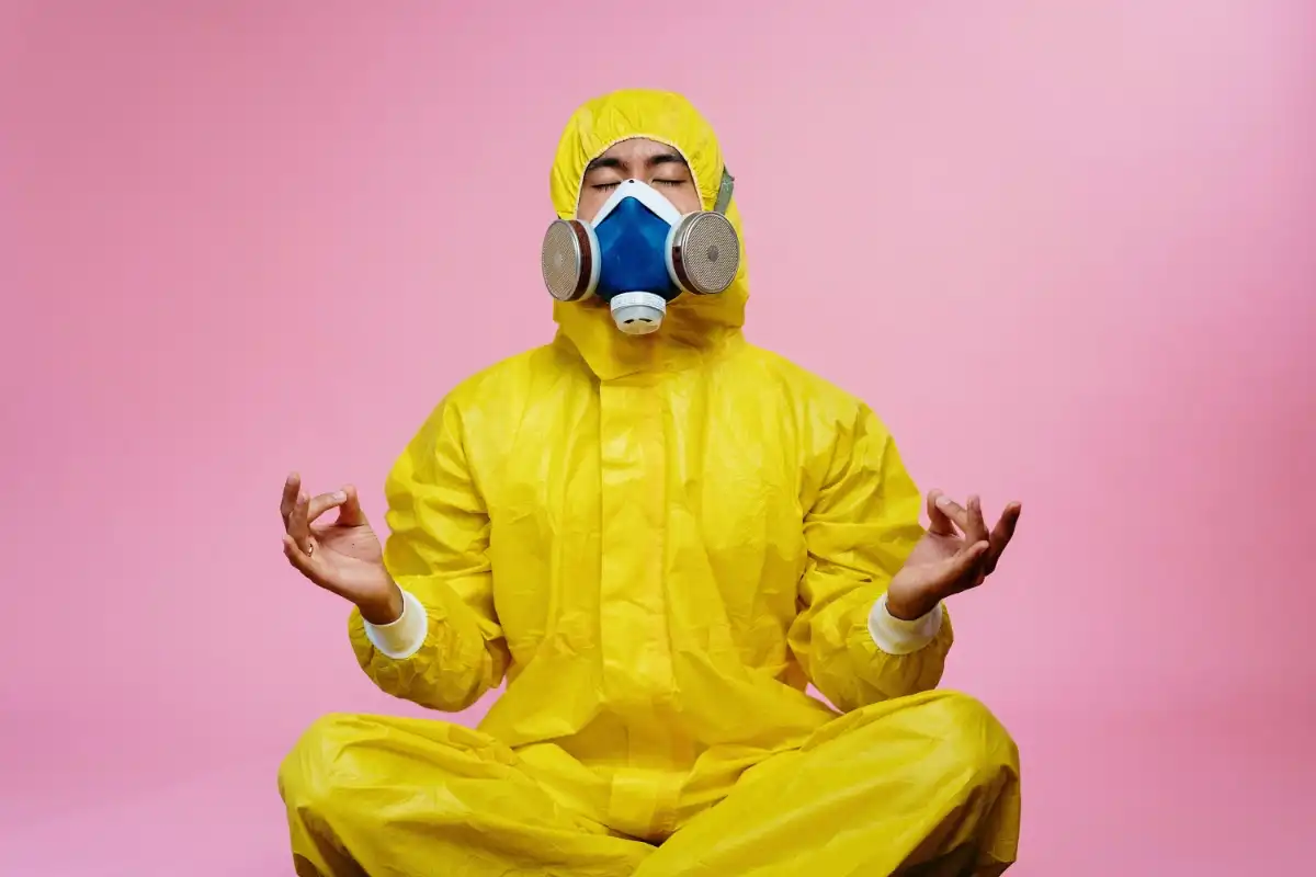 Person meditating in a yellow hazmat suit - Happy Mind Training Blog | Simple Mindfulness Practices
