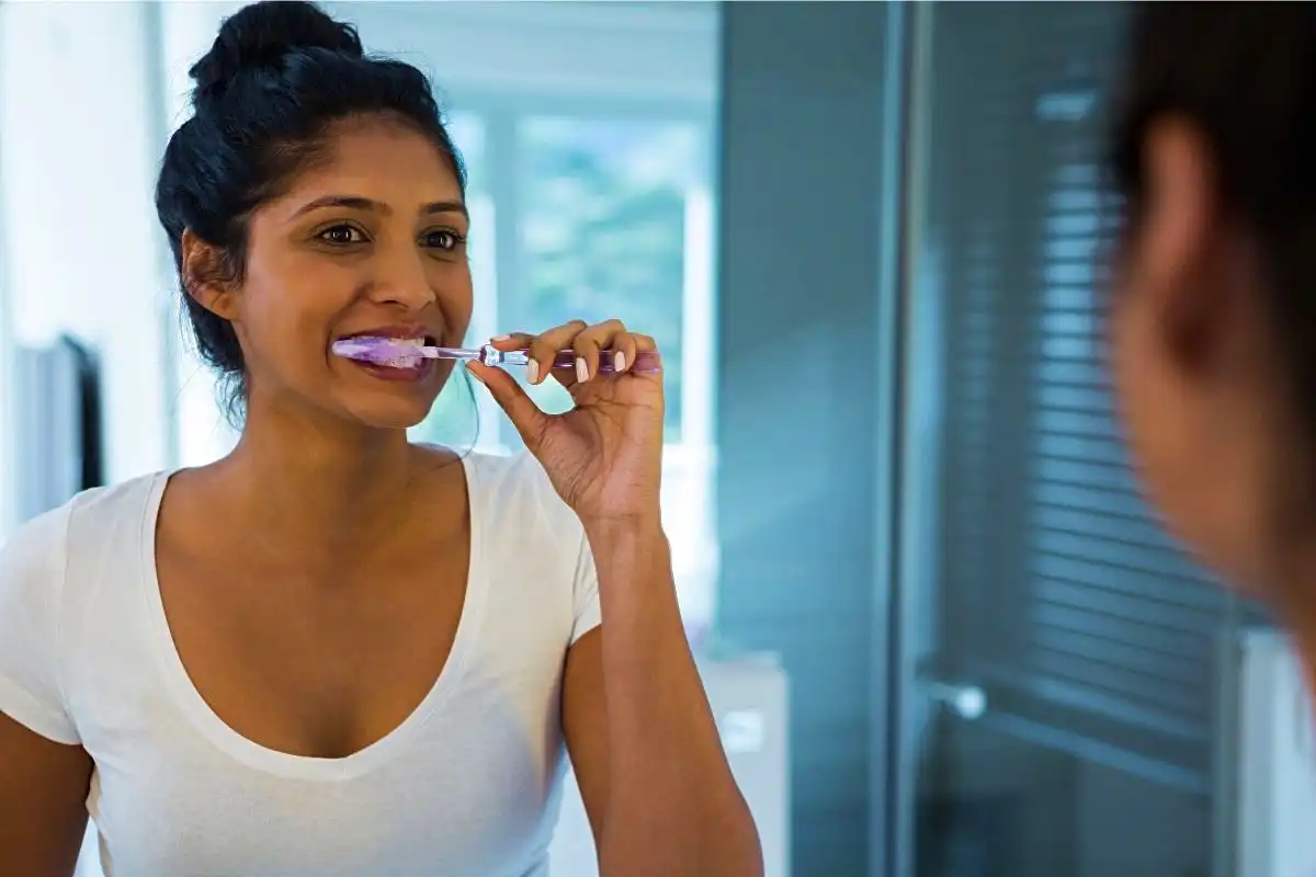 Woman brushing her teeth - Happy Mind Training Blog | Why We All Need Routine